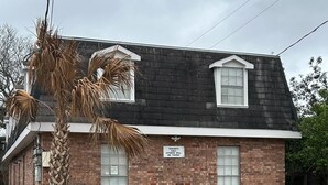 A two-story brick building with a black roof and white trim. There is a sign on the front that reads "TENANTS ONLY, OTHERS WILL BE TOWED." - Metairie magic, 2 bedroom gem  (Metairie)