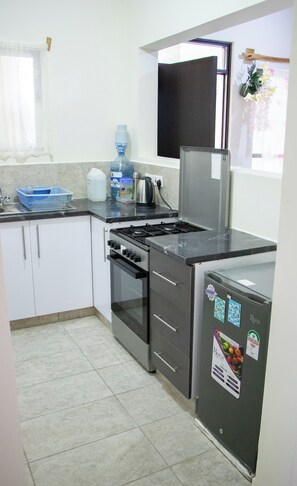 Enjoy cooking in this well-equipped kitchen with a gas stove, oven, and refrigerator.