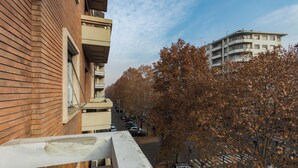 A multi-story residential building with a brick facade and a balcony. - Elegante e Raffinato in Zona Crocetta by Wonderful Italy (Turin)