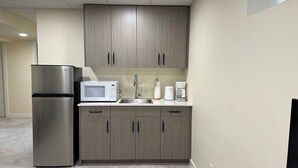 A compact kitchen with a refrigerator, microwave, sink, and coffee maker. - Private Cozy 1 Bedroom Basement Suite (Winnipeg)