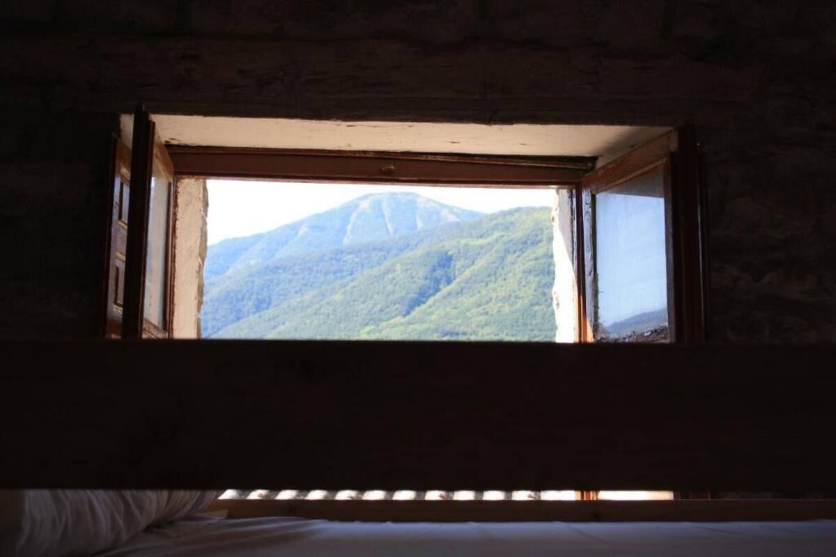 Uma janela com vista para uma montanha.