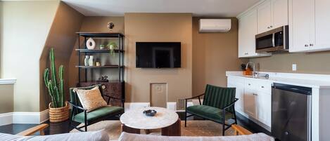 A modern living room with a sofa, a coffee table, and a bookshelf.