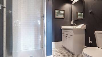 Deluxe Studio | Bathroom | Shower, designer toiletries, hair dryer, towels