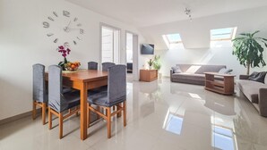 A spacious living area with a dining table, chairs, a sofa, and a TV. - Awesome apartment in Dobrzyca with WiFi (Dobrzyca)