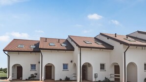 A row of white buildings with brown tiled roofs and multiple windows. - Awesome apartment in Dobrzyca with WiFi (Dobrzyca)