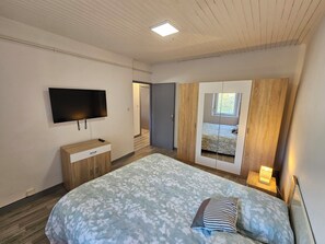 1 dormitorio, tabla de planchar con plancha, ropa de cama