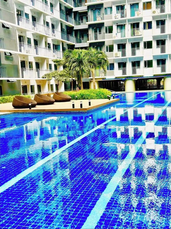 Relax by the pool surrounded by comfortable lounge chairs.
