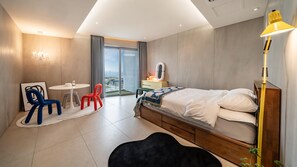 Une chambre d’hôtel moderne équipée d’un lit, d’un bureau, d’une chaise et offrant une vue sur l’extérieur.