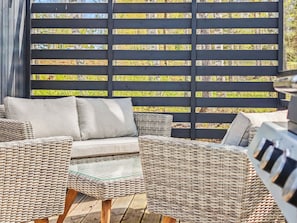 A wicker outdoor seating area with a black backdrop. - Villa sirius 56 by Interhome (Kemiönsaari)