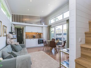 A modern kitchen with white cabinets and a dining area with a table and chairs.