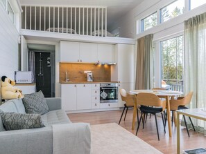 A modern apartment with a loft bedroom, a kitchenette, a dining area, and a living room. - Villa otava 15 by Interhome (Kemiönsaari)