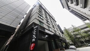 A modern building with a prominent 'Luxe Hotel' sign, a parking entrance, and a glass facade. - Nowon Luxe hotel (Seoul)