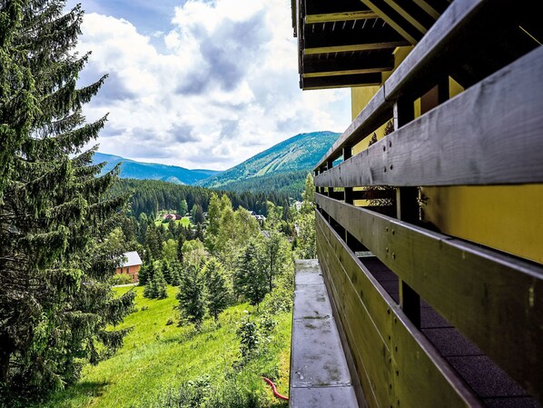 Enjoy breathtaking views of the surrounding landscape from this balcony.