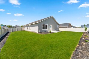 A single-story house with a sloped roof, a front porch, and a well-maintained lawn.