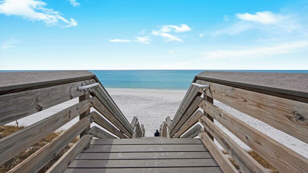 A wooden staircase leading to a beach with a clear view of the ocean. - Hidden Beach Villas (Santa Rosa Beach)