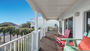 Enjoy al fresco dining on the covered balcony with a view of the surrounding landscape.