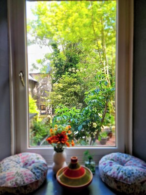 Enjoy a peaceful retreat with a garden view from the room's large window.