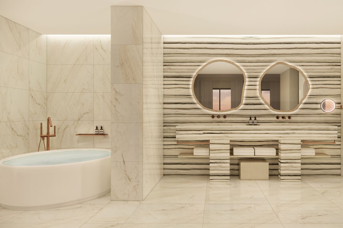 A modern bathroom with a freestanding bathtub, a vanity with a marble countertop, and a large mirror.