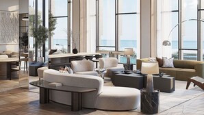 A spacious living area with large windows, a modern sofa set, a coffee table, and a view of the ocean. - Delano Dubai (Dubai)