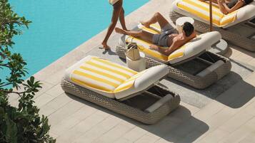 Una piscina al aire libre, cabañas de piscina (de pago), sombrillas