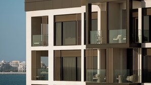 A modern building with multiple balconies, large windows, and a view of the sea. - Delano Dubai (Dubai)