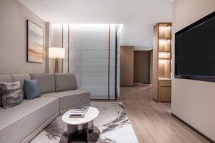 Exclusive Suite, 2 Bedrooms, Garden View | Living room | 65-inch LED TV with cable channels, pay movies