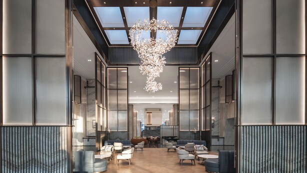 A spacious lobby with a modern chandelier, seating areas, and a view of the kitchen in the background. - Pullman Taizhou Shenxianju  (Taizhou)