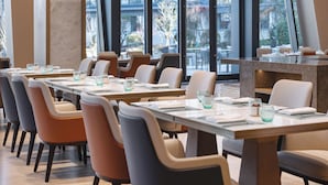 A modern restaurant with high tables and chairs, large windows offering a view of the cityscape. - Pullman Taizhou Shenxianju  (Taizhou)