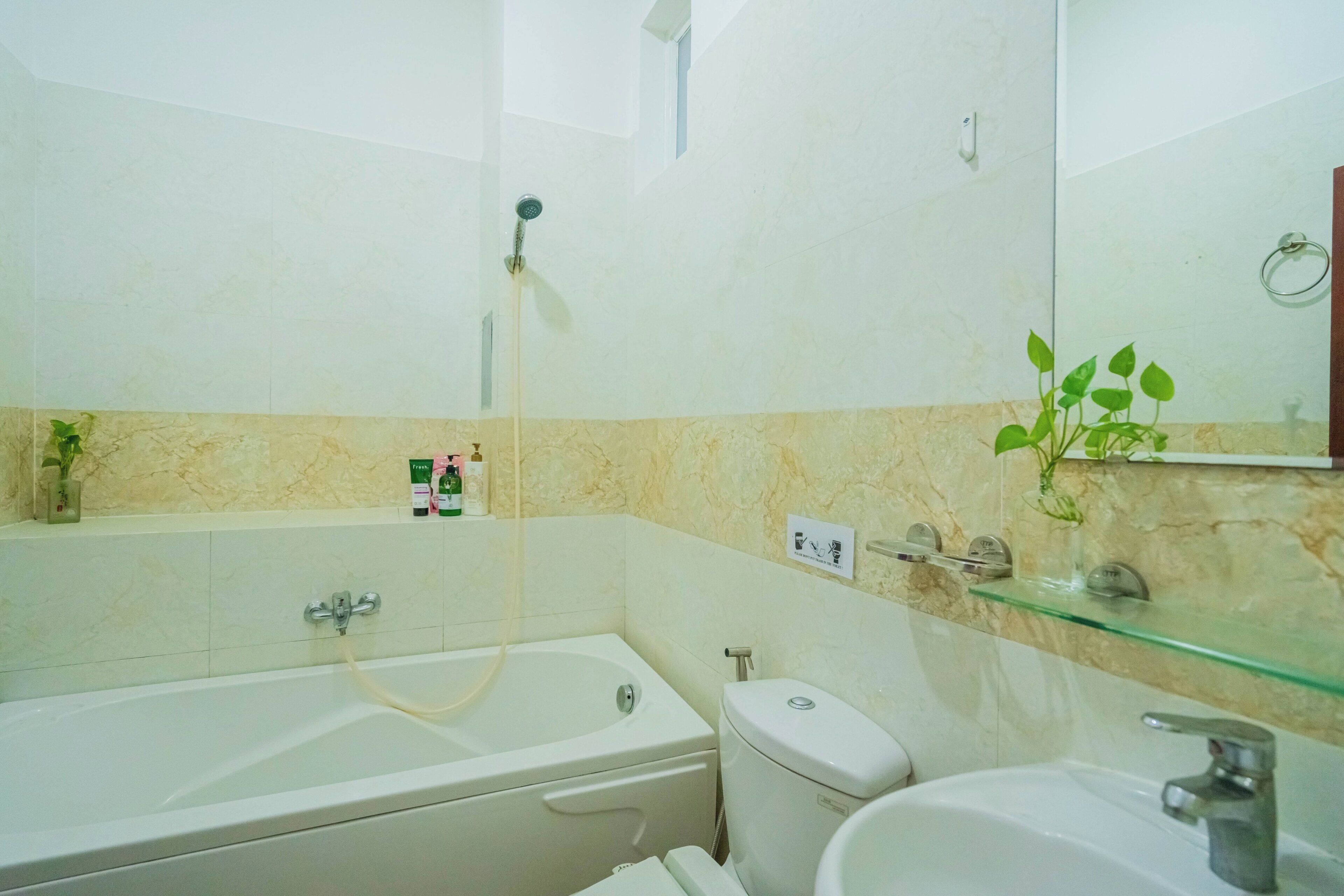 A bathroom with a bathtub, toilet, and sink.