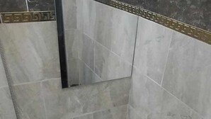 A bathroom with a white sink, a toilet, and a shower area. - LUNA HOTEL (Cairo)