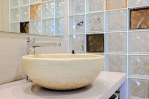 A bathroom with a large, round, beige ceramic sink and a modern faucet. - Marina Rey – 400m from beach, Côte d’Azur vibe (Villeneuve-Loubet)