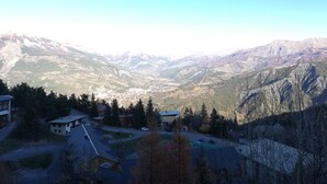 A mountainous landscape with a valley and a small town.