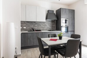 Apartment | Private kitchen | Electric kettle, highchair, dining tables