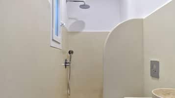 A bathroom with a shower, toilet, and sink.