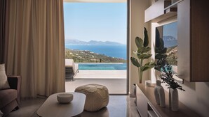 Un salon moderne avec vue sur la mer et les montagnes.