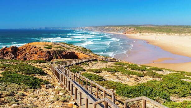 A coastal landscape with a wooden boardwalk leading to a beach. - Destination for Couple, Surfers, Hikers, and Nature Lovers! (Carrapateira)