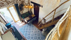 A room with a patterned floor, a wooden staircase, a bench, and a hanging light fixture. - Destination for Couple, Surfers, Hikers, and Nature Lovers! (Carrapateira)