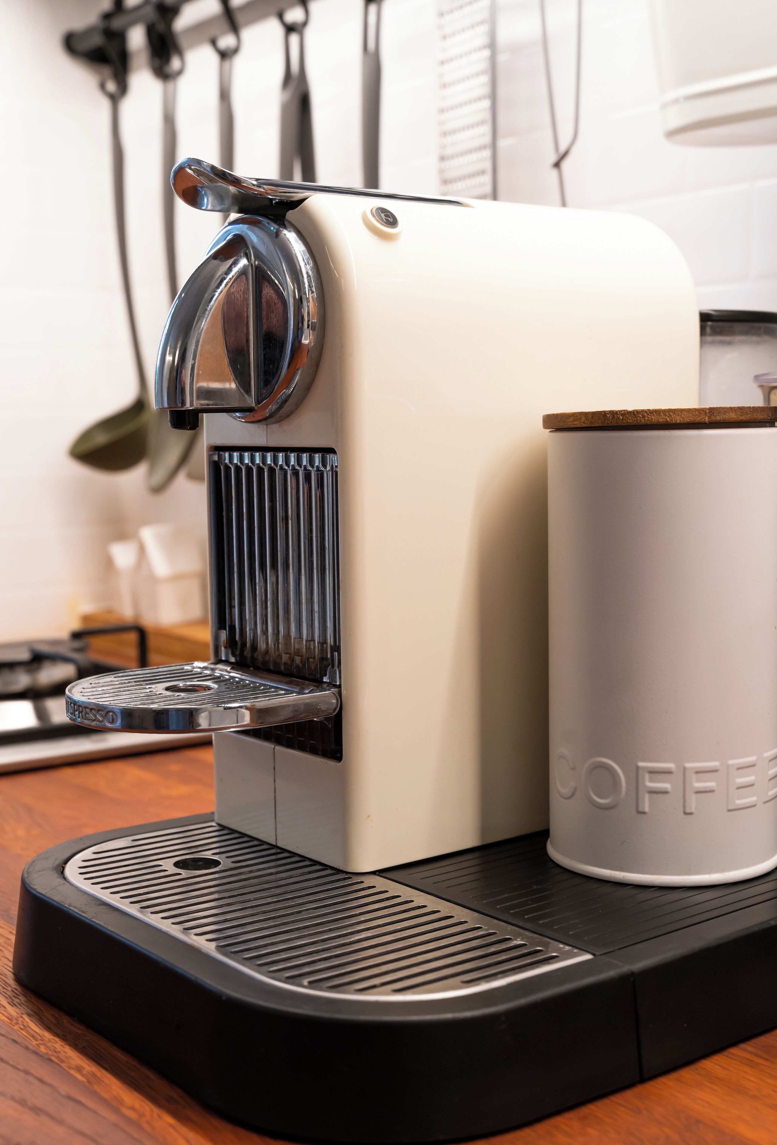 A coffee machine with a cup of coffee on a table.