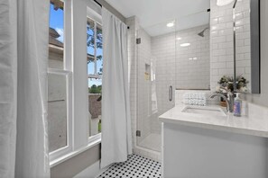 Shower, hair dryer, towels, shampoo