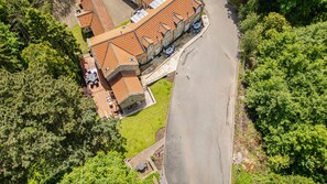 An aerial view of a building with a tiled roof, surrounded by lush greenery. - East Hampton, Sandsend Retreats at Saltmoore - East Hampton (Whitby)