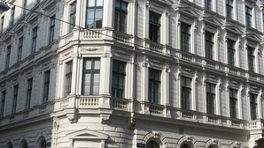 A large, historic building with a classical architectural style, featuring multiple windows and a prominent corner entrance. - Central family Apartment A16 with AC (Vienna)