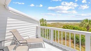 A balcony with white railings, two lounge chairs, and a view of the beach and ocean. - Beach Club Villa 38 - Oceanfront Gem! Walkout! (Isle of Palms)