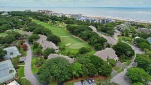 A golf course with a view of the ocean and beach, surrounded by residential buildings. - Fairway Dunes 14 - Tennis! Pool! Beach! (Isle of Palms)