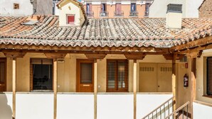 A building with a tiled roof, wooden balconies, and a staircase. - Charming Central Madrid Loft (Madrid)