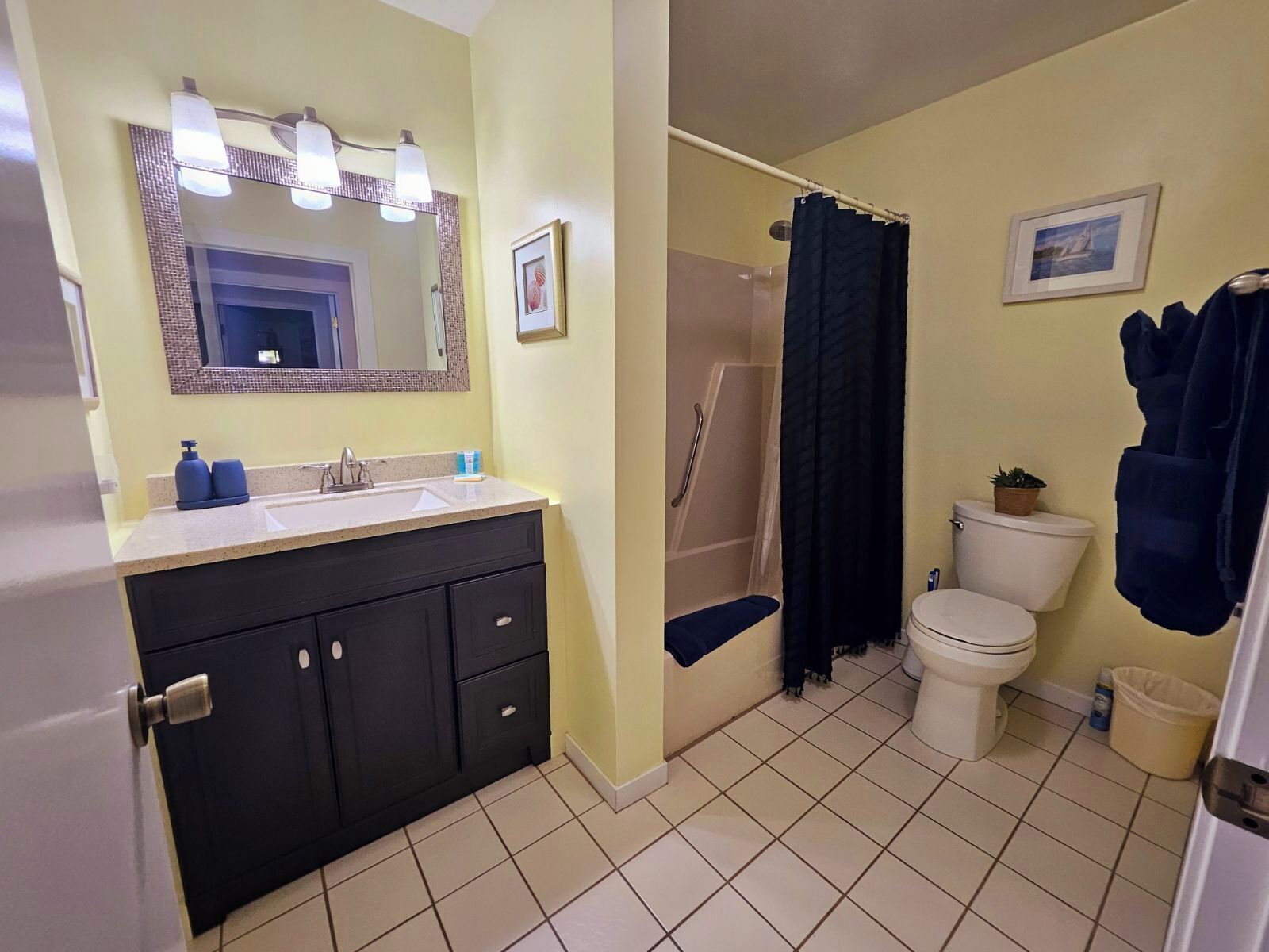 A bathroom with a sink, mirror, and toilet.