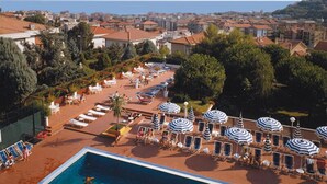 A resort with a large pool, sun loungers, and umbrellas. - I Morelli 7 Pax - Two Bedroom Apartment, Sleeps 7 (Pietra Ligure)