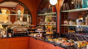 A buffet with various food items and a coffee station. - Ginette à la Folie (Paris)