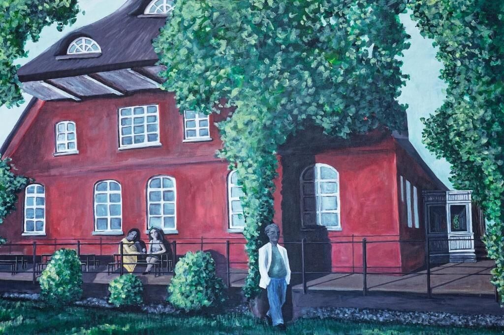 A red building with multiple windows and a covered porch.