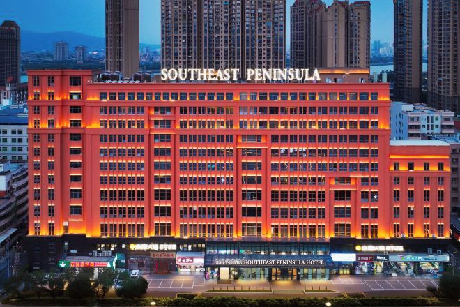 A multi-story hotel with a prominent sign reading 'Southeast Peninsula Hotel.'