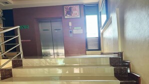 A set of marble-tiled stairs leading to a room with a door marked "A2". - OYO 75506 Ratchapruek Apartment Suphanburi  (Suphan Buri)